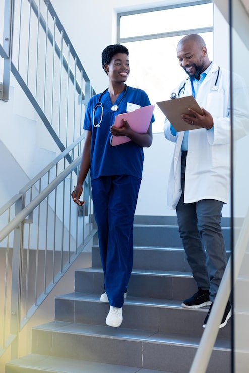 vertical happy african american female male doctor talking hospital staircase hospital medical healthcare services_13339 337788